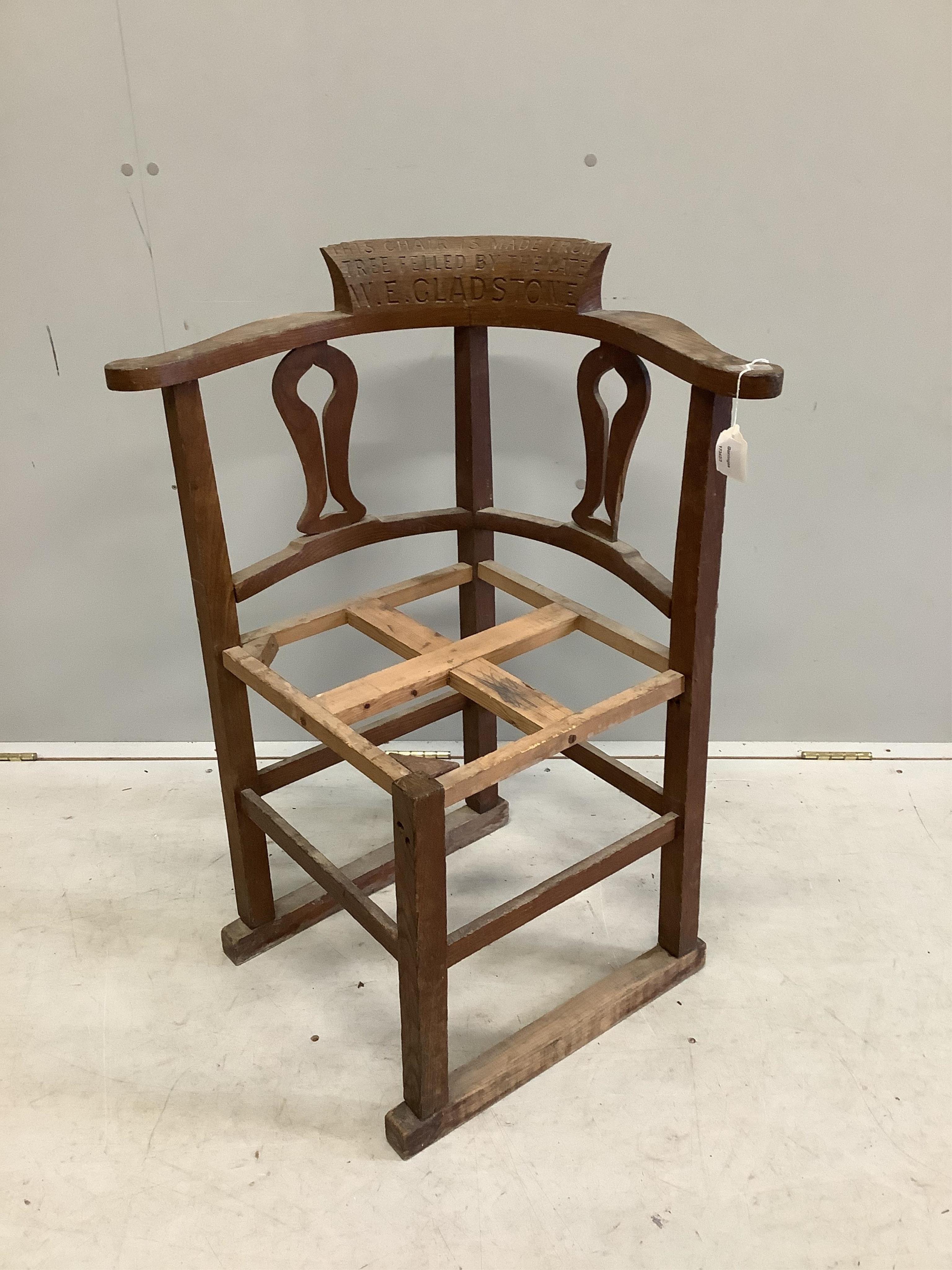 W. E. Gladstone, an oak corner chair, width 65cm, depth 57cm, height 84cm. Condition - fair, lacks seat upholstery